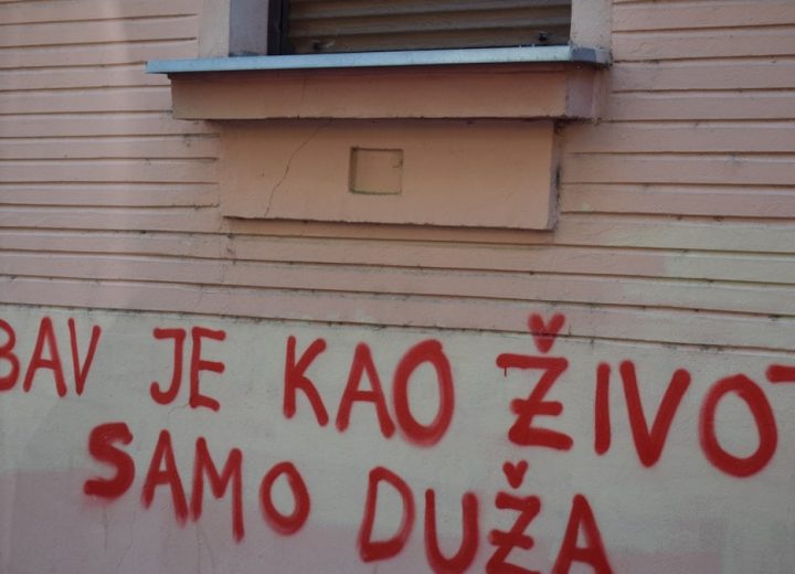 Red graffiti on a building wall